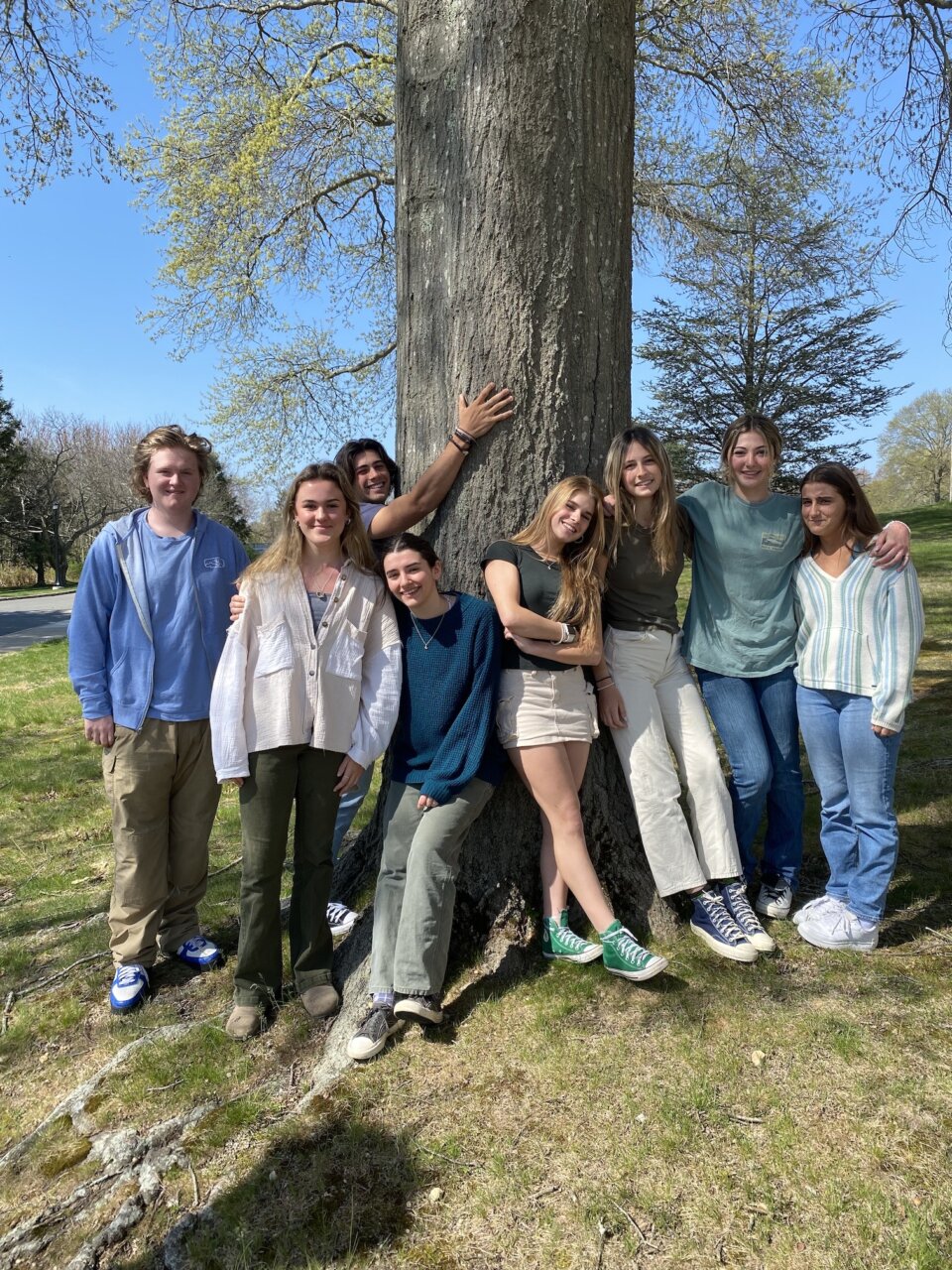 Certificate group students stand in front of a tree together.