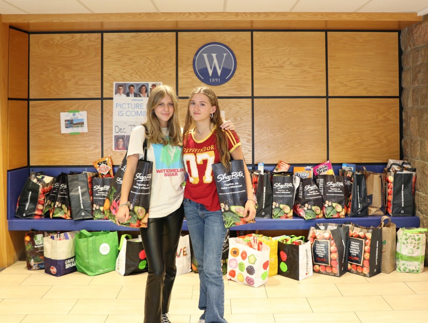 Williams students pose in front of donations for Gemma Food Drive.