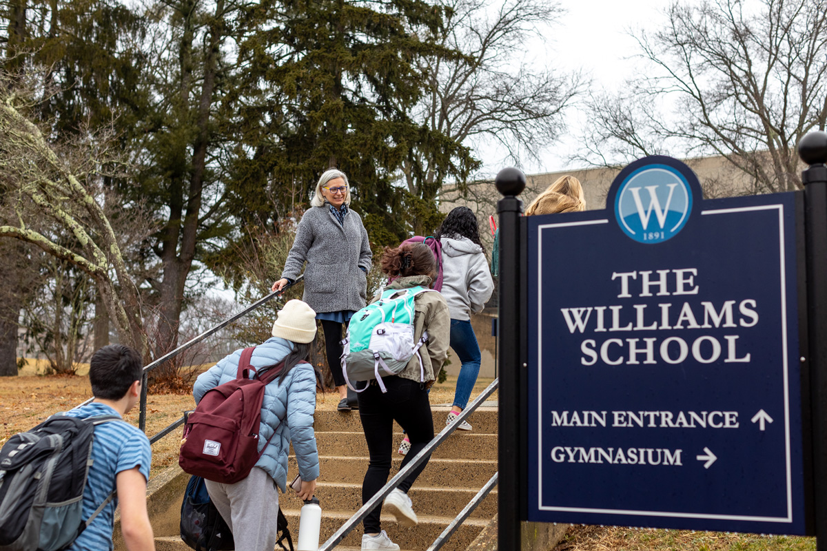 Students arriving at school walking up Williams steps
