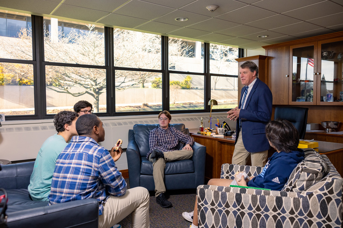 Williams Head of School, Mark Fader talks to students in his office