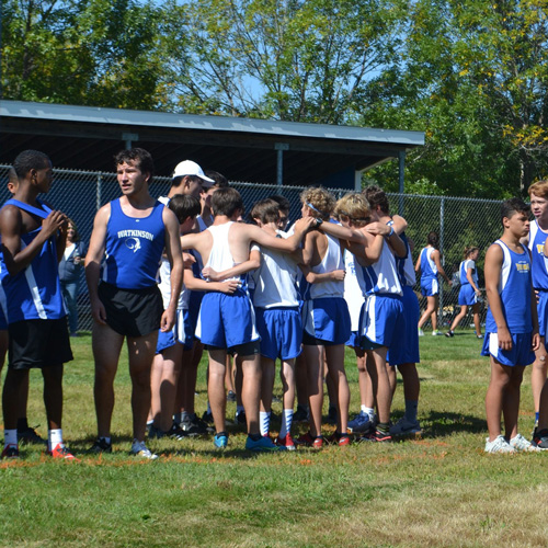 cross country boys team in huddle