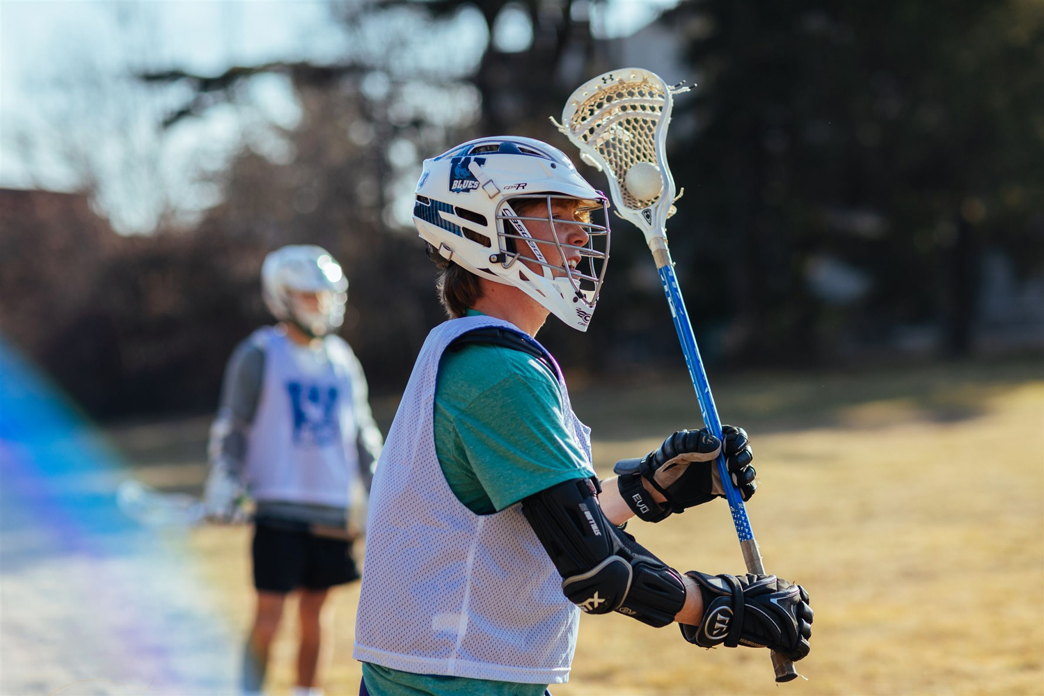 student lacrosse player holding stick