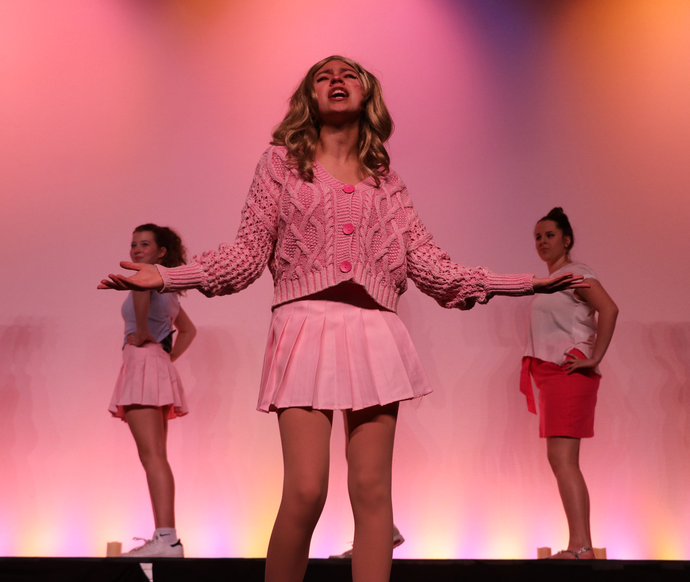 students singing on stage during legally blonde production at school