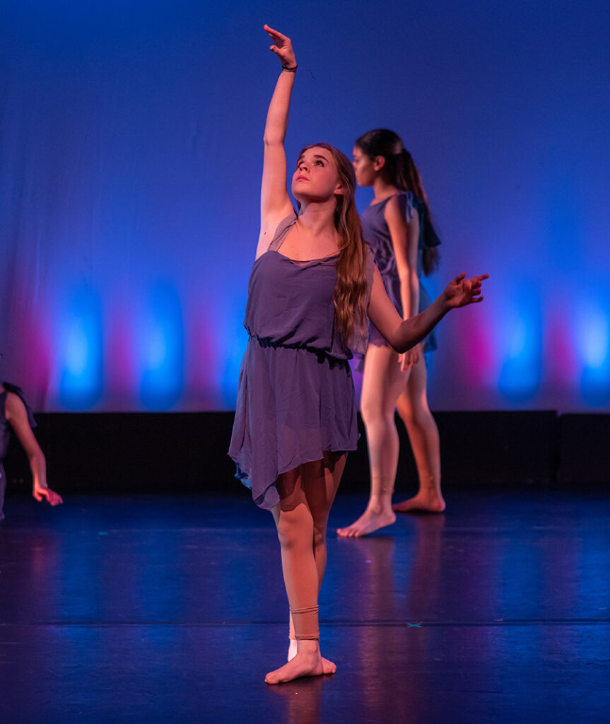Student dancer performing with arms extended