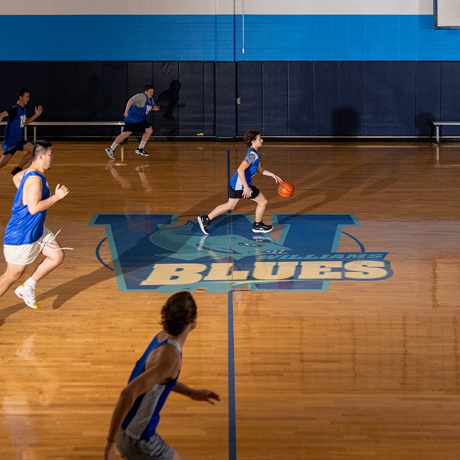 boys team playing basketball in gym