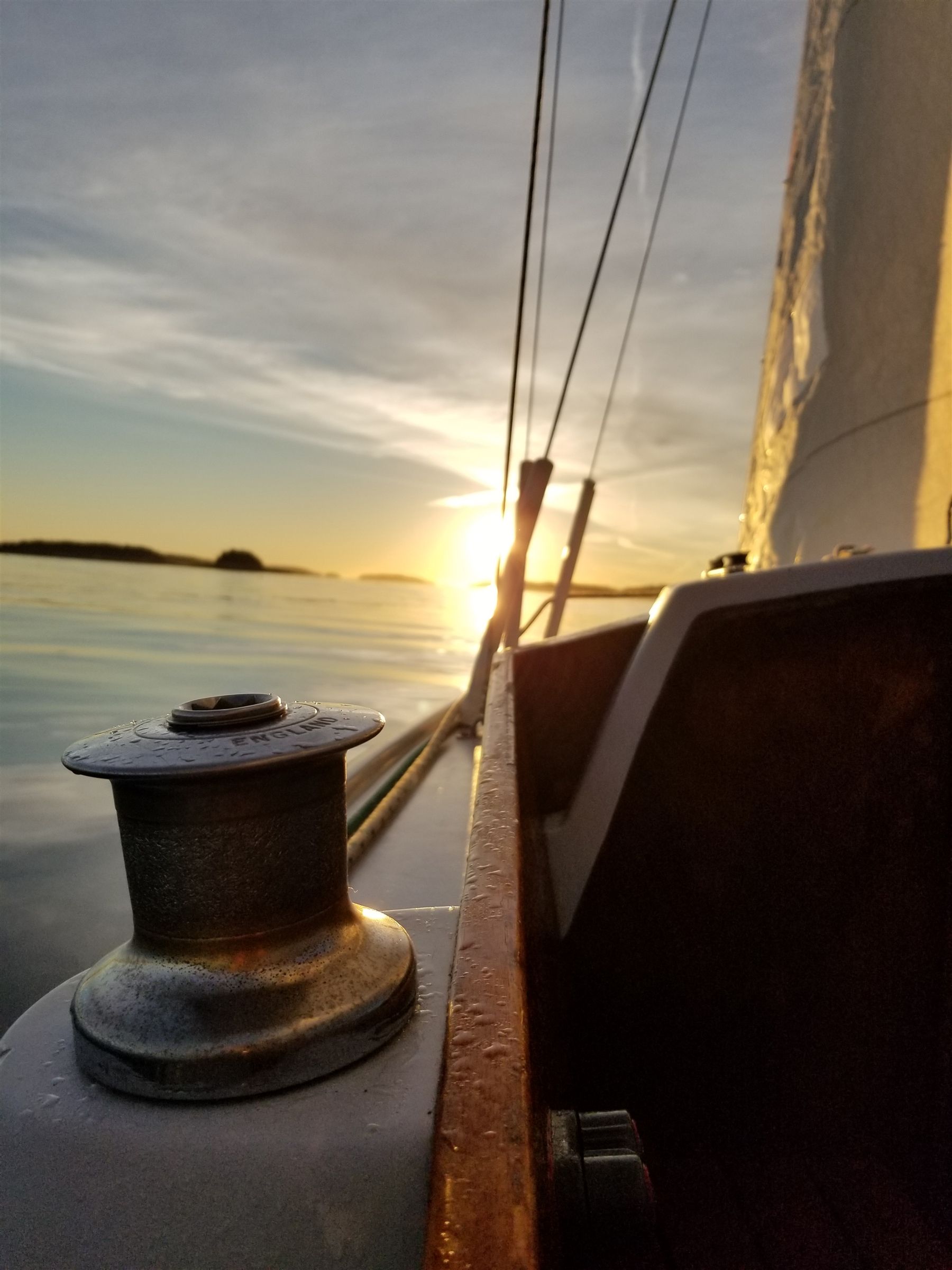 side of sailboat at sunset