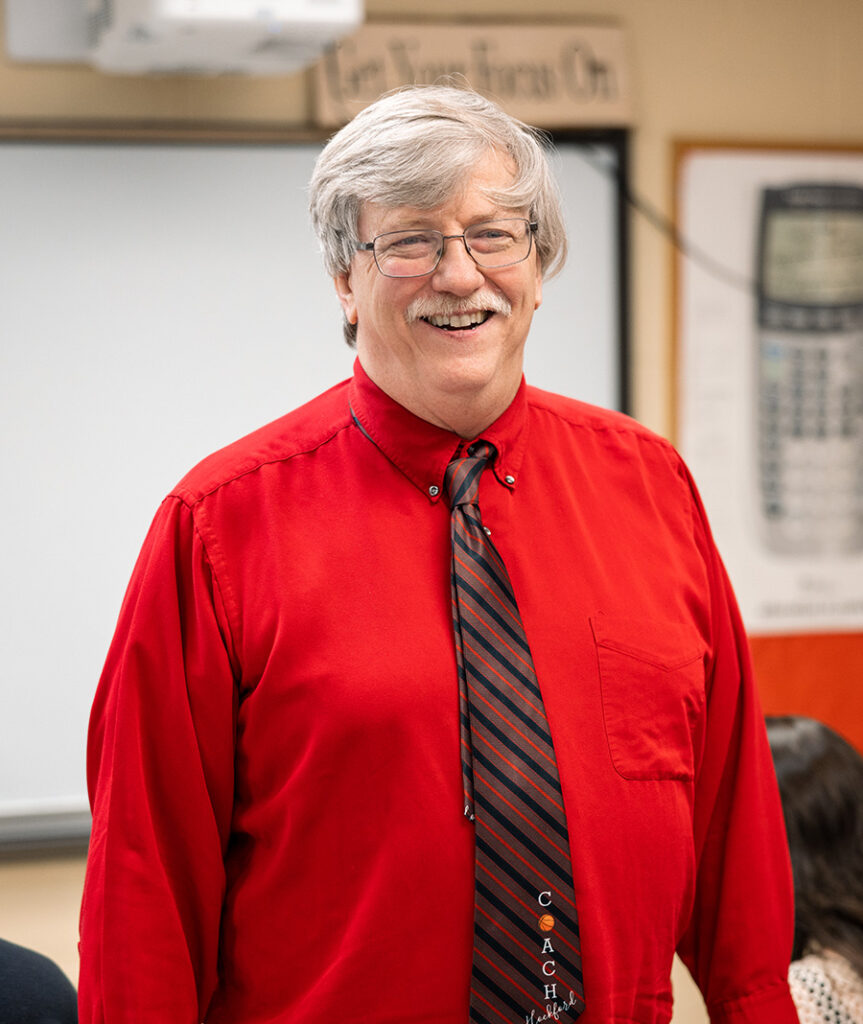 Scott Hockford standing in a classroom and smiling
